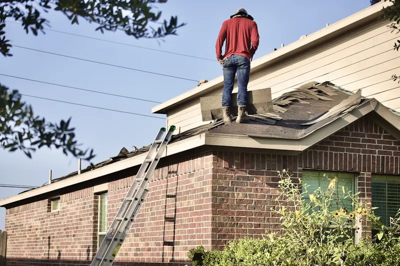 Professional roofer working on a residential roof in Brink